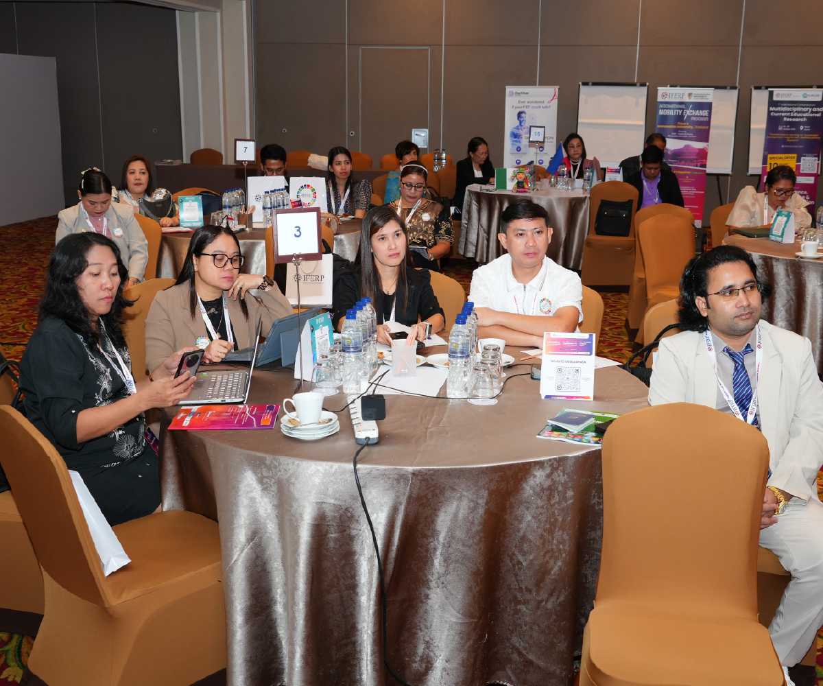 Delegates discussing displayed research at a previous IFERP conference